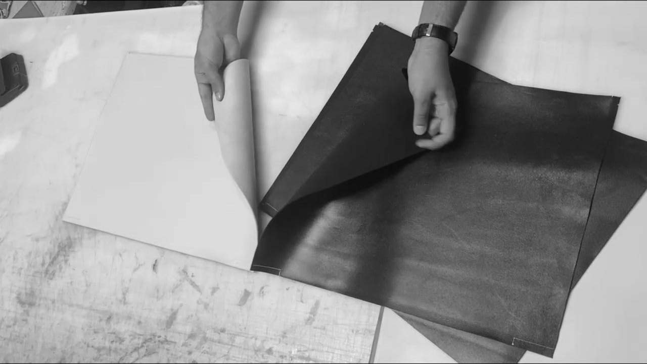 Selecting leather sheets on the workshop table