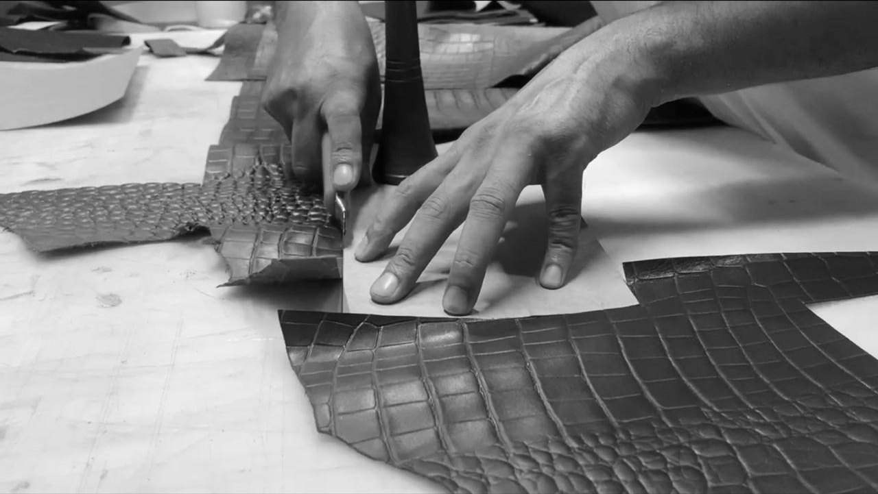 Hand-cutting embossed leather in the workshop